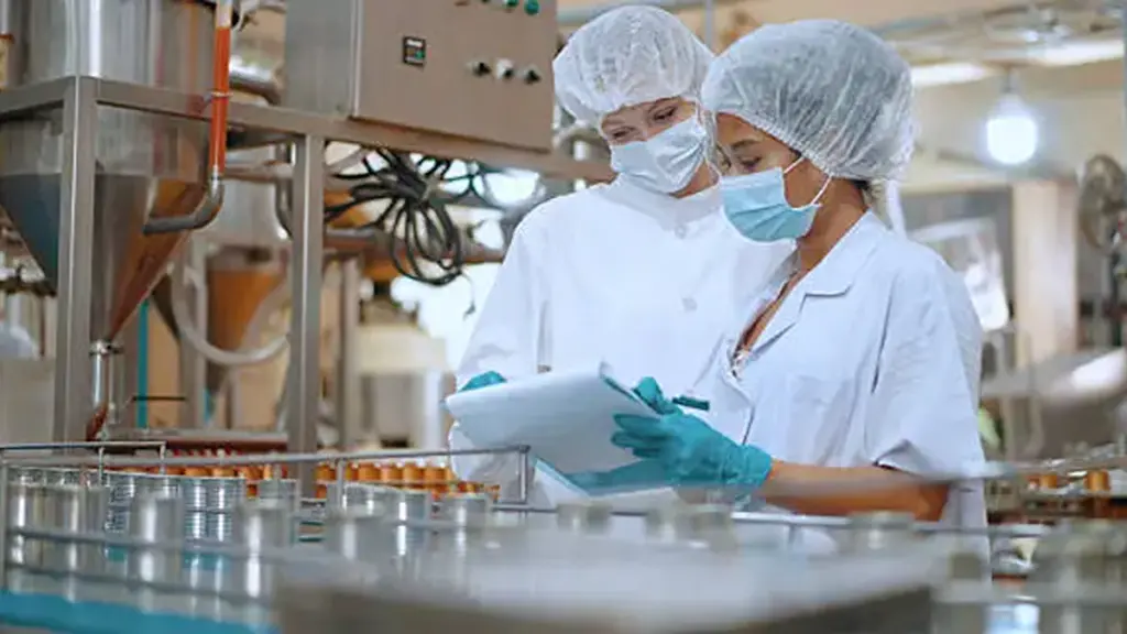 Team reviewing production efficiency on food processing plant