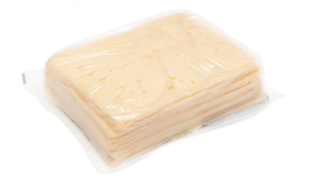 A block of yellow sliced cheese wrapped in clear plastic film against a white background.